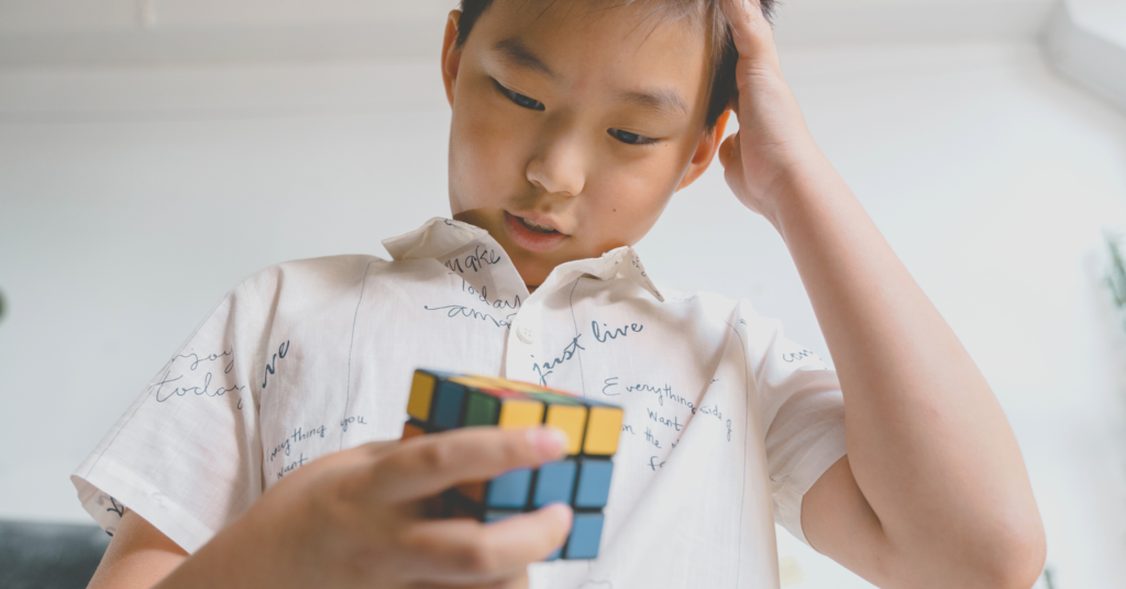 Kid Doing a Hard Thing - figuring out how to solve a 3x3 rubik's cube