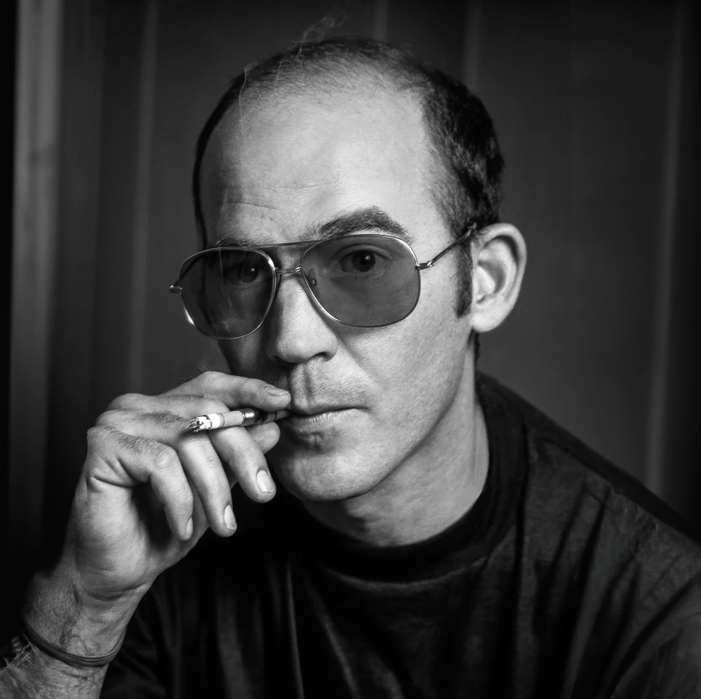 Hunter Stockton Thompson in his iconic pose of smoking a cigarette 